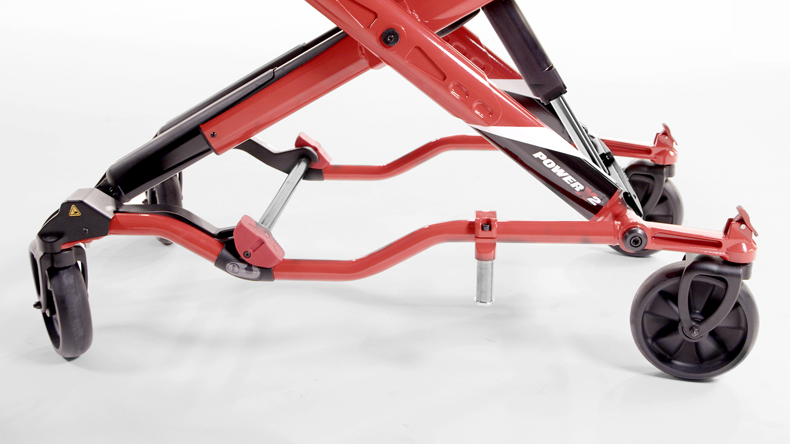 Close-up of the Ferno Power X2 directional wheel locks located directly above both front-end wheels
